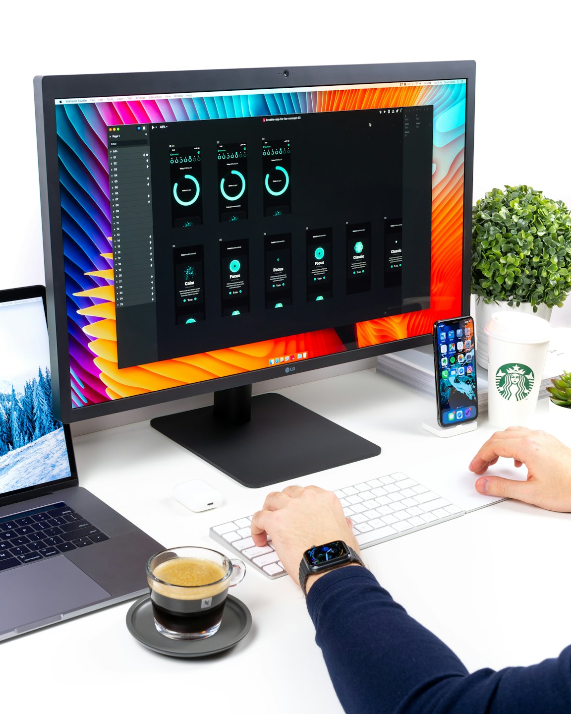 Designer working on UI mockups on a desktop computer.