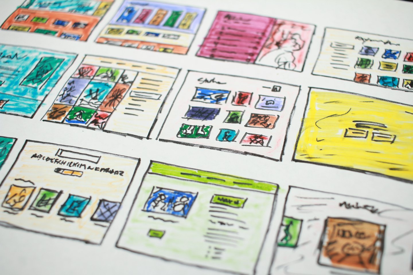 Hand drawn website wireframe sketches on white paper.